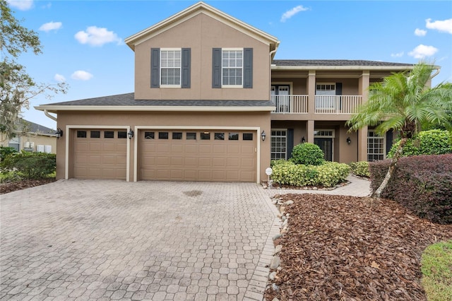 view of front of property with a garage and a balcony