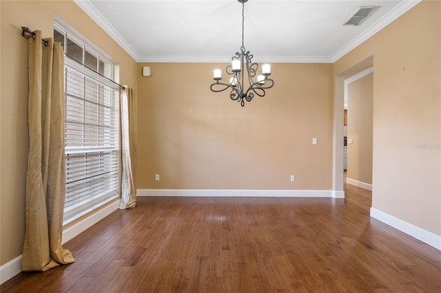 spare room with ornamental molding, a notable chandelier, and dark hardwood / wood-style floors