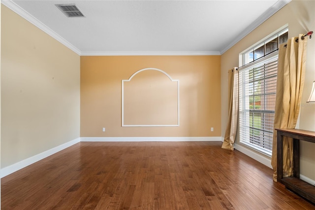 spare room with crown molding and dark hardwood / wood-style floors