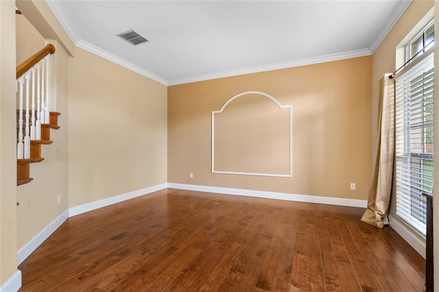 empty room featuring dark wood-type flooring and crown molding