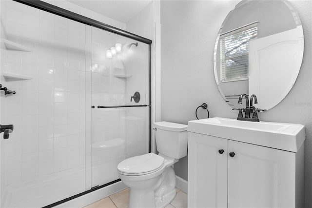 bathroom featuring vanity, tile patterned floors, toilet, and an enclosed shower