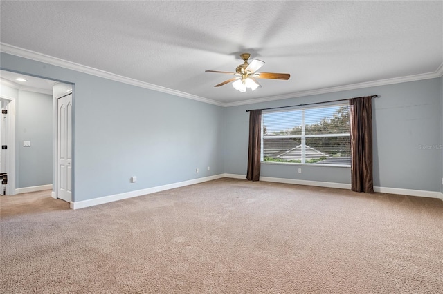 carpeted spare room featuring ornamental molding, a textured ceiling, and ceiling fan