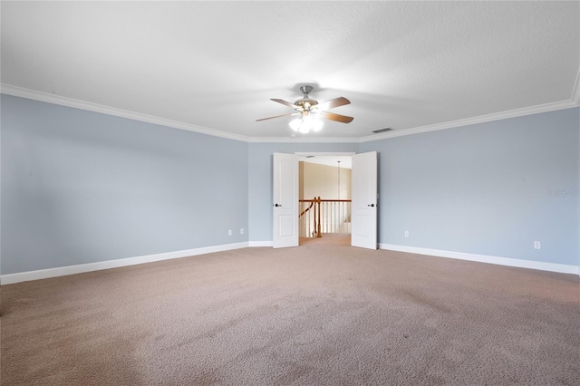 carpeted spare room featuring ornamental molding and ceiling fan