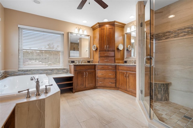 bathroom featuring vanity, independent shower and bath, tile patterned flooring, and ceiling fan