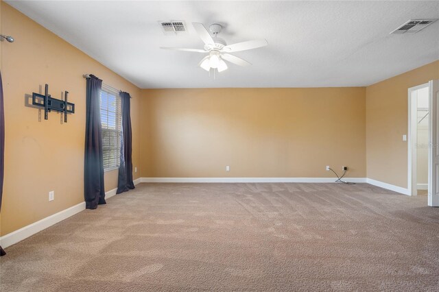 unfurnished room with ceiling fan and light colored carpet