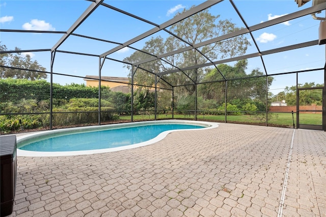 view of pool with a patio area and a lanai