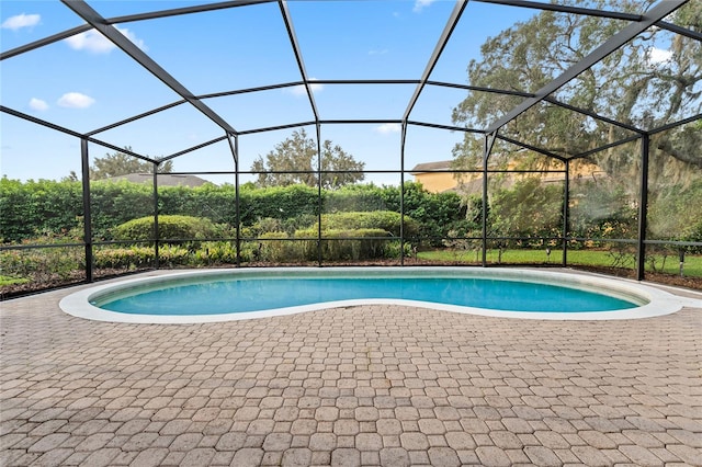 view of swimming pool featuring a patio area and a lanai