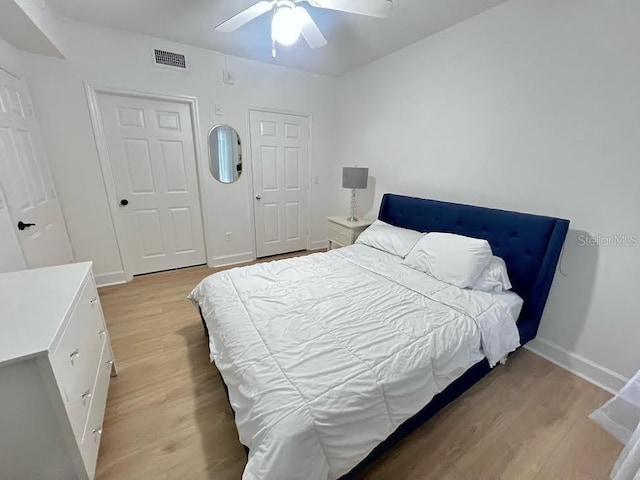 bedroom with ceiling fan and light wood-type flooring