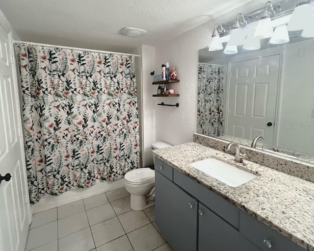 full bathroom with shower / tub combo, a textured ceiling, toilet, vanity, and tile patterned floors