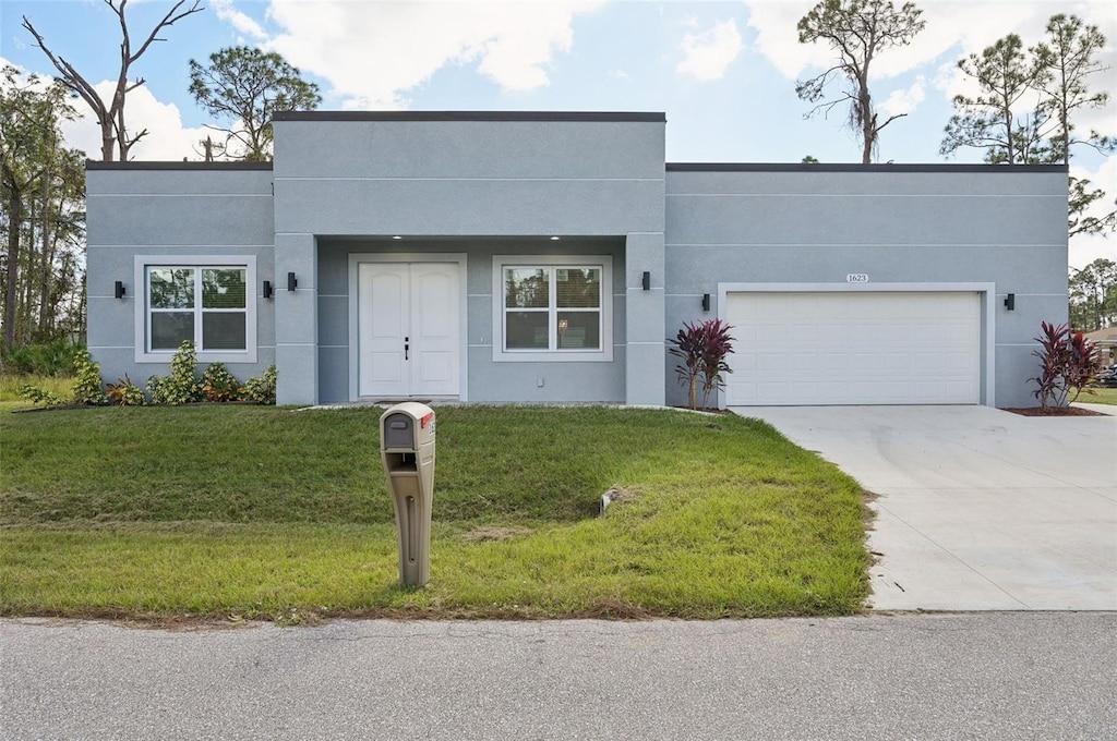 view of front of home featuring a garage and a front lawn