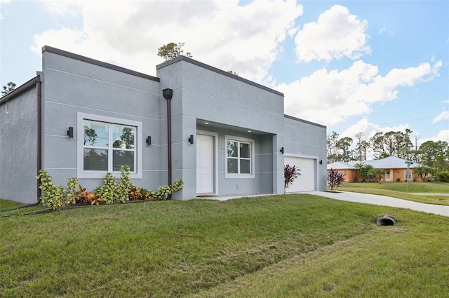 view of front of property featuring a front yard and a garage