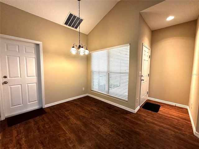 entrance foyer with high vaulted ceiling, a chandelier, and dark hardwood / wood-style floors