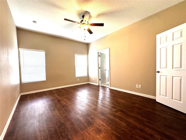 unfurnished bedroom with dark wood-type flooring, a textured ceiling, and ceiling fan