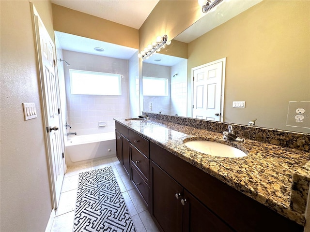 bathroom with a bathtub, tile patterned floors, and vanity