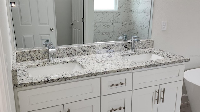 bathroom with vanity and a bathing tub