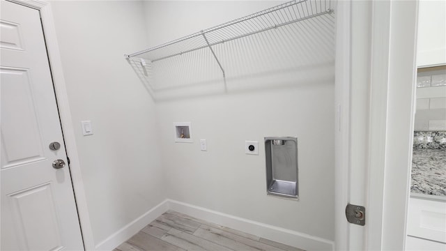 washroom with electric dryer hookup, washer hookup, and light wood-type flooring