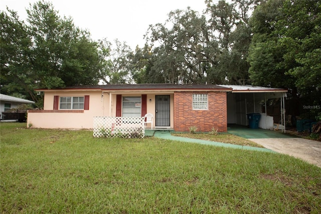 single story home featuring a front lawn and a carport