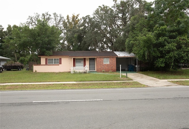 single story home with a front lawn and a carport