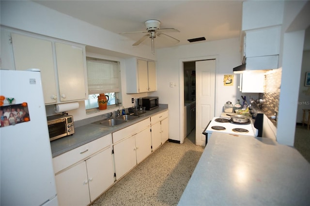 kitchen with white appliances, white cabinets, sink, and ceiling fan