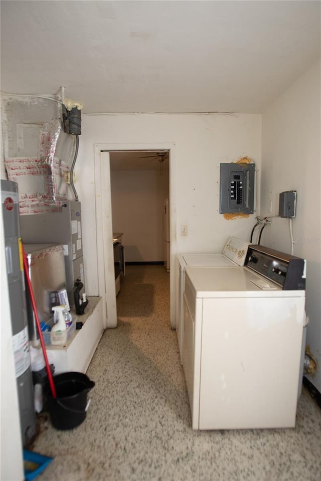 clothes washing area with washer and clothes dryer, electric water heater, and electric panel