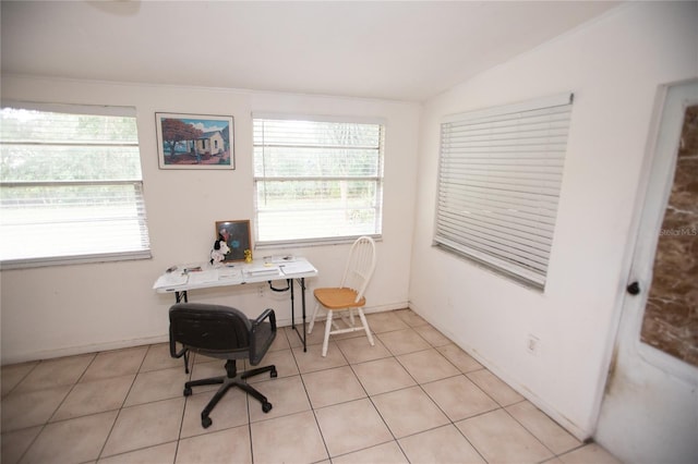 office featuring lofted ceiling, light tile patterned floors, and a wealth of natural light