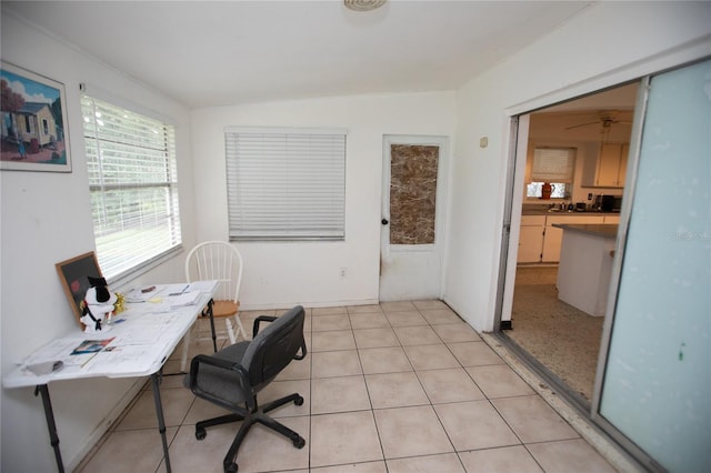 office area featuring ceiling fan, light tile patterned flooring, and lofted ceiling