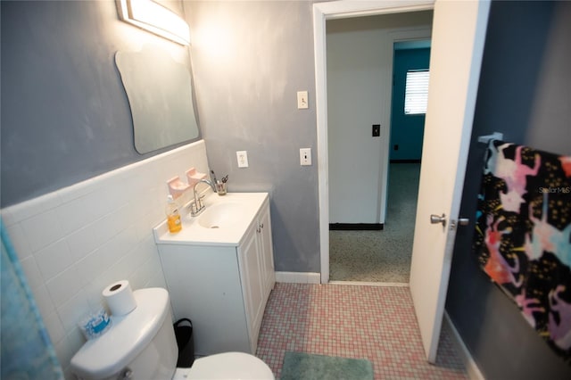 bathroom with vanity, tile walls, toilet, and tile patterned floors