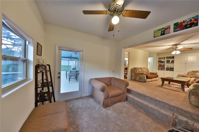 living room with carpet floors, ceiling fan, and a wealth of natural light