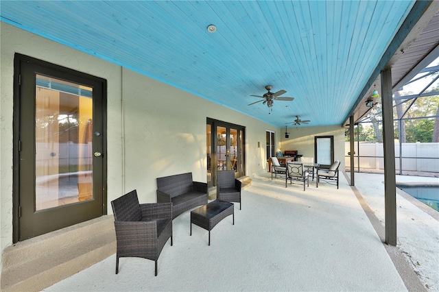 view of patio / terrace featuring a fenced in pool, french doors, a lanai, and ceiling fan