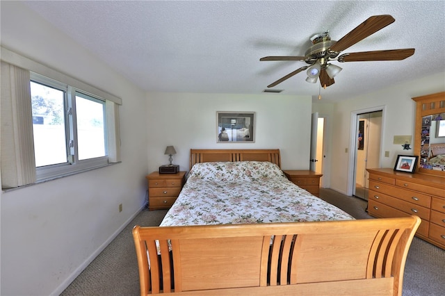 bedroom featuring ceiling fan, a textured ceiling, and dark colored carpet