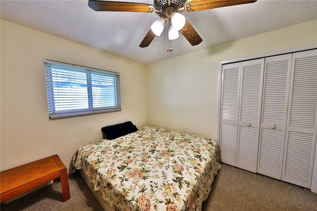 carpeted bedroom featuring a closet, a textured ceiling, and ceiling fan