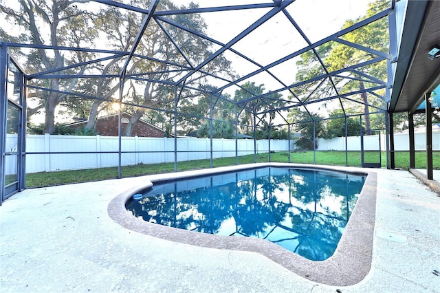 view of swimming pool featuring glass enclosure and a patio