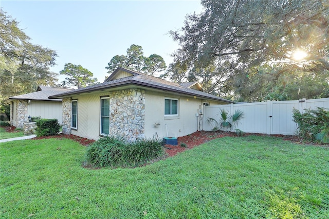 view of side of property with a yard