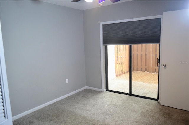 carpeted empty room featuring ceiling fan