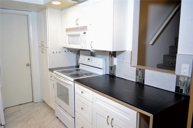 kitchen with white cabinets, decorative backsplash, and white appliances