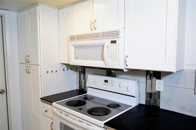 kitchen with white appliances, tasteful backsplash, and white cabinetry