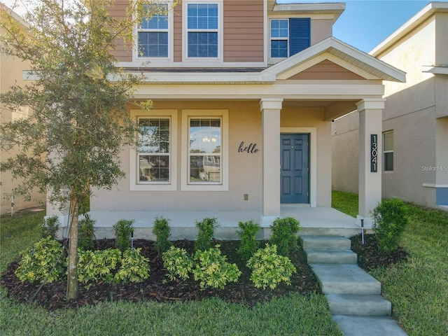 13041 Inkwell Aly, Winter Garden, FL 34787 - doorway to property with stucco siding and a porch