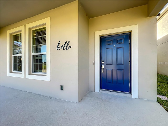 13041 Inkwell Aly, Winter Garden, FL 34787 - doorway to property featuring stucco siding and covered porch