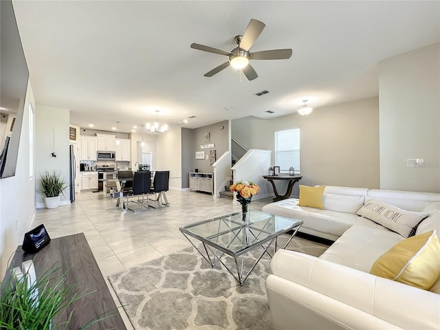 13041 Inkwell Aly, Winter Garden, FL 34787 - living area featuring stairway, visible vents, baseboards, and ceiling fan with notable chandelier