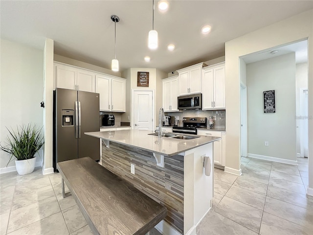 13041 Inkwell Aly, Winter Garden, FL 34787 - kitchen with white cabinetry, a sink, backsplash, and appliances with stainless steel finishes