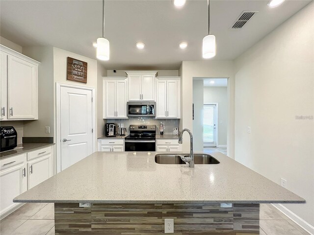 13041 Inkwell Aly, Winter Garden, FL 34787 - kitchen with visible vents, a sink, a center island with sink, appliances with stainless steel finishes, and white cabinetry
