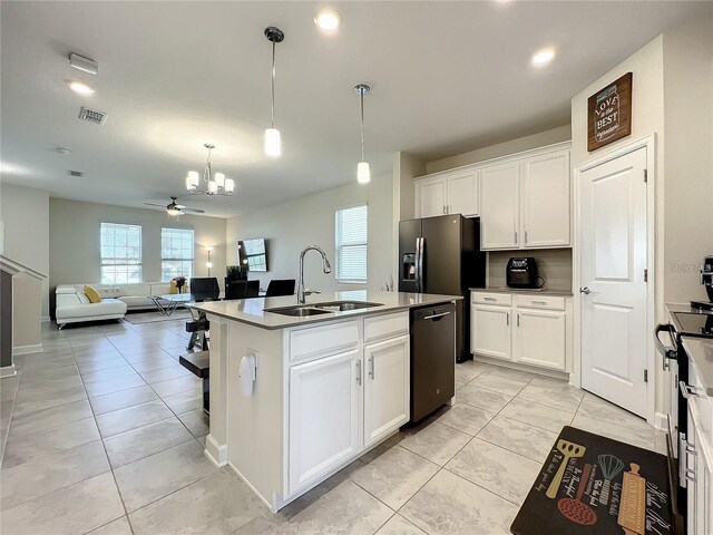 13041 Inkwell Aly, Winter Garden, FL 34787 - kitchen with white cabinets, dishwashing machine, a sink, and light tile patterned floors