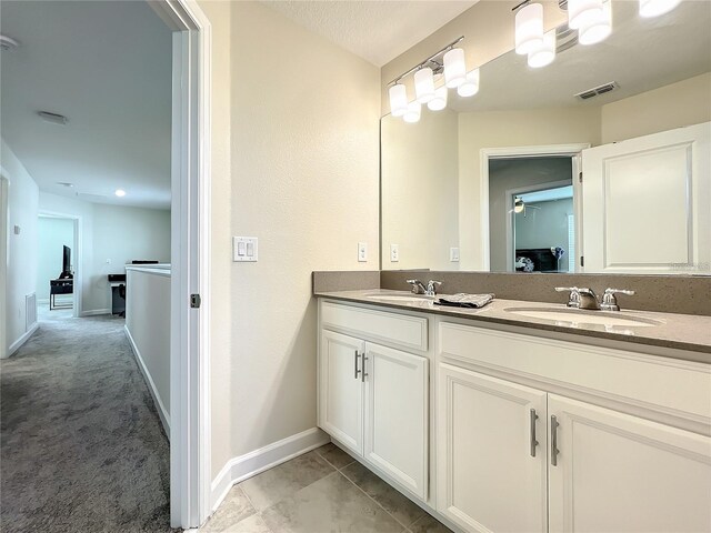 13041 Inkwell Aly, Winter Garden, FL 34787 - bathroom with baseboards, visible vents, a sink, and double vanity