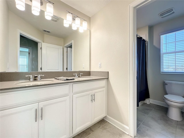 13041 Inkwell Aly, Winter Garden, FL 34787 - bathroom featuring visible vents, a sink, double vanity, and toilet