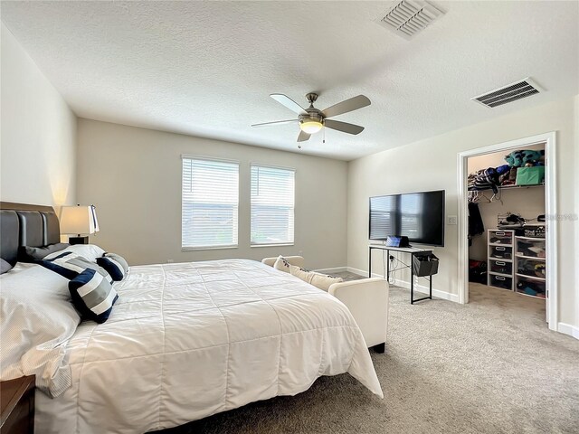 13041 Inkwell Aly, Winter Garden, FL 34787 - carpeted bedroom featuring a spacious closet, visible vents, a ceiling fan, and a textured ceiling