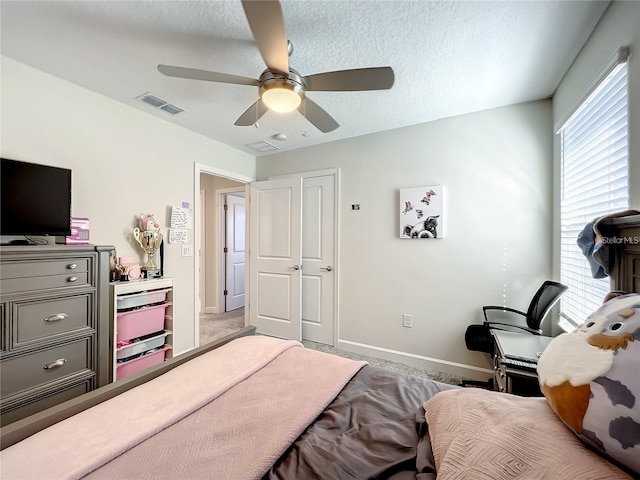 13041 Inkwell Aly, Winter Garden, FL 34787 - bedroom featuring a textured ceiling, visible vents, baseboards, and ceiling fan