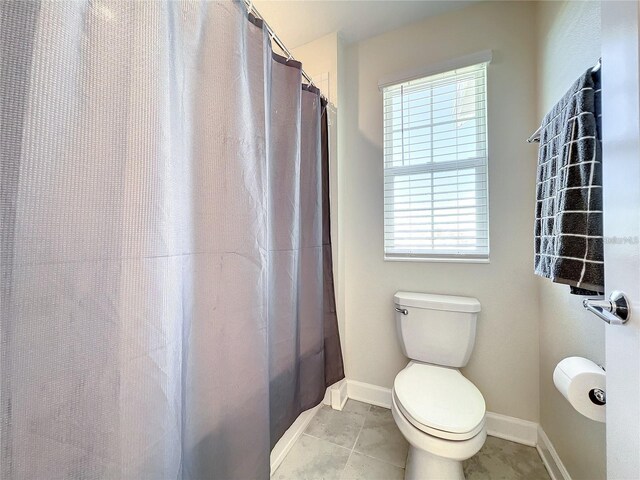 13041 Inkwell Aly, Winter Garden, FL 34787 - full bath with plenty of natural light, curtained shower, tile patterned floors, and toilet