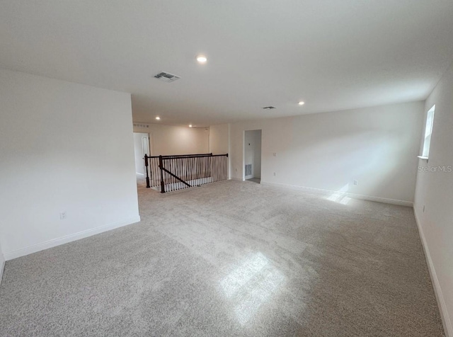 2949 Sunset Dr, New Smyrna Beach, FL 32168 - unfurnished room featuring visible vents, baseboards, recessed lighting, and carpet flooring