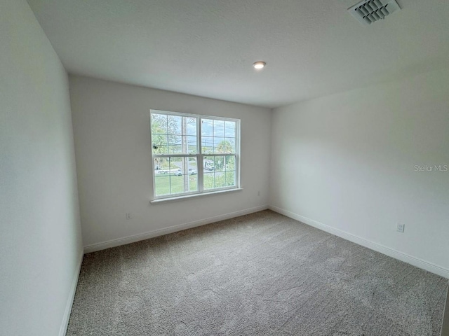 spare room featuring carpet flooring