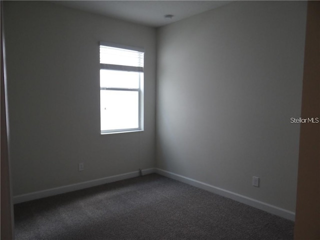 carpeted empty room featuring a wealth of natural light